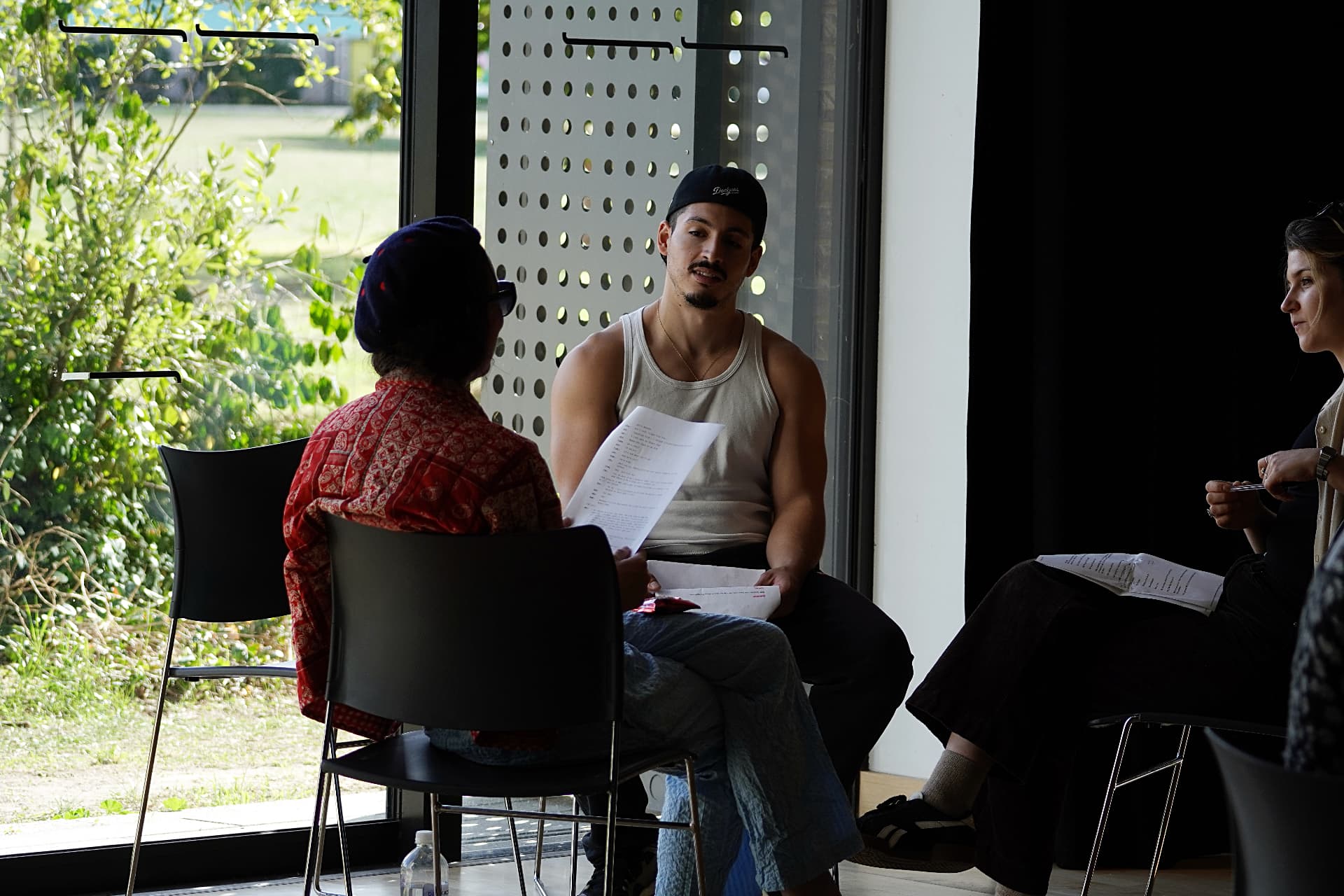 Two actors running lines by the window